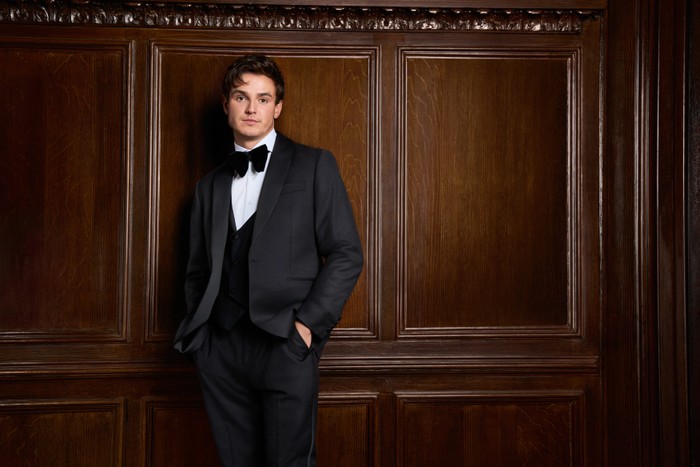 Sam Prince for Made in Chelsea Sam Prince pictured for Made in Chelsea. He is wearing a full tuxedo and has his hand in his pocket and is looking ahead.