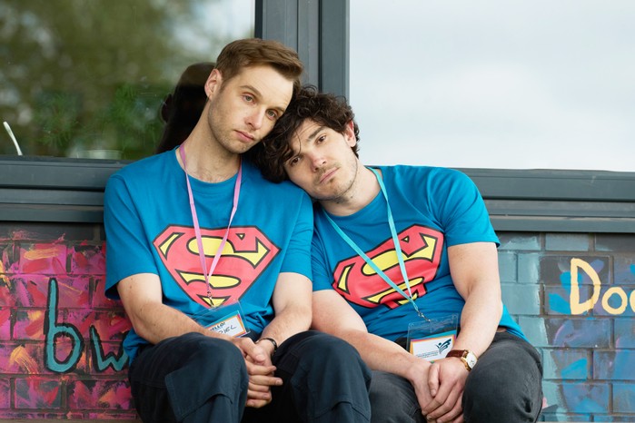 Lost Boys & Fairies Gabriel and Andy wearing Superman t-shirts, sitting next to one another, with their heads leaning on one another