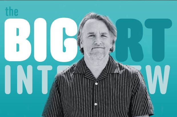 Richard Linklater A black and white still of Richard Linklater against a blue backdrop that reads Big RT Interview