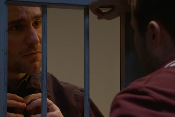 EastEnders Ben Callum cell Tony Clay as Callum Highway signing love to Max Bowden as Ben Mitchell through a prison cell window in EastEnders.