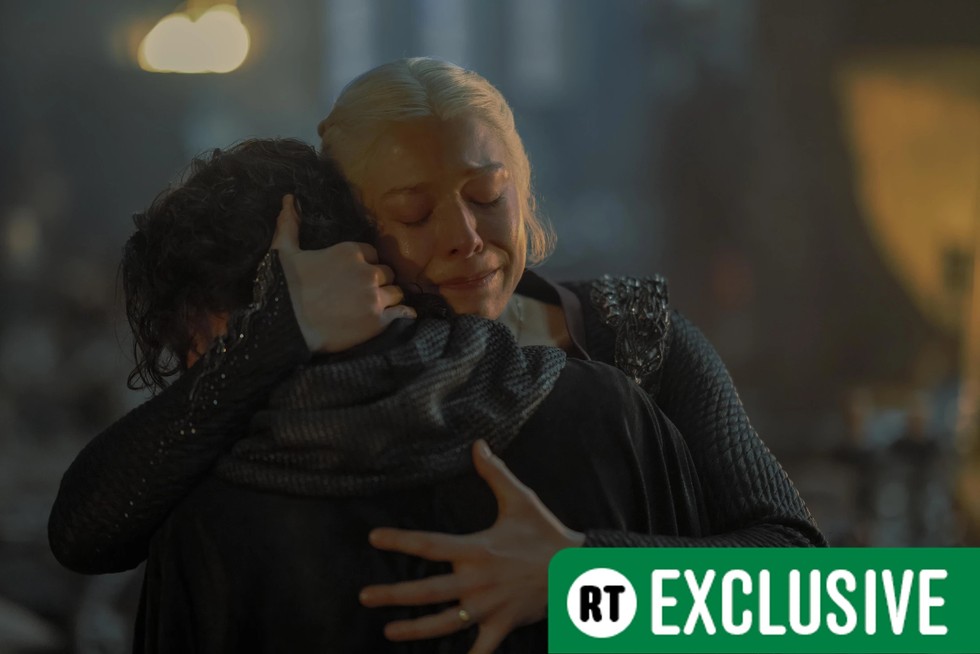 Emma D'Arcy as Rhaenyra Targaryen in House of the Dragon Emma D'Arcy as Rhaenyra Targaryen in House of the Dragon hugging a boy with RT Exclusive in the bottom right of the frame
