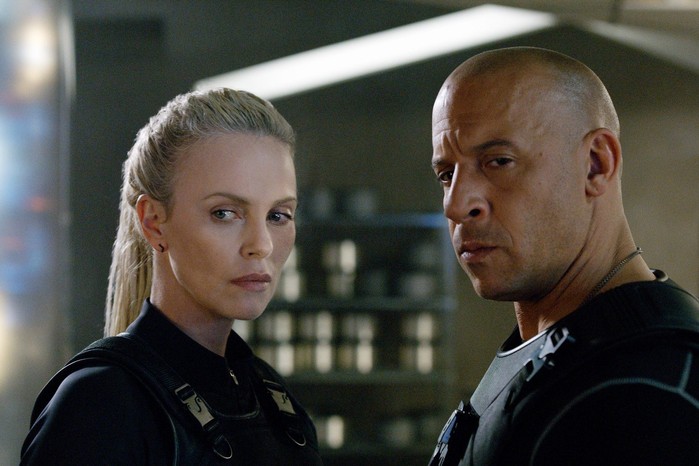 fast-furious Vin Diesel as Dominic Toretto, Charlize Theron as Cipher in The Fate of the Furious standing together looking serious