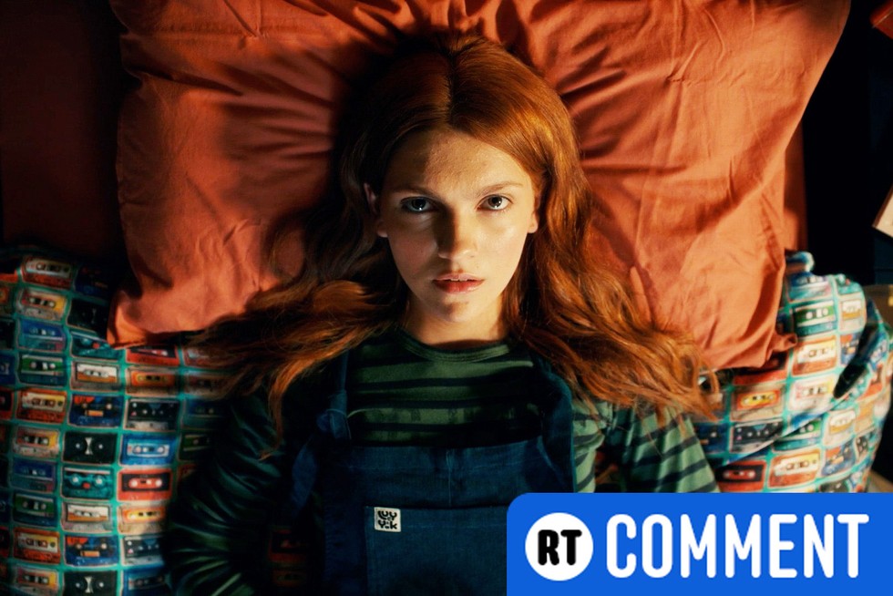 Geek Girl Harriet lying on her bed, looking up at the ceiling - with a blue RT comment banner in the bottom right corner