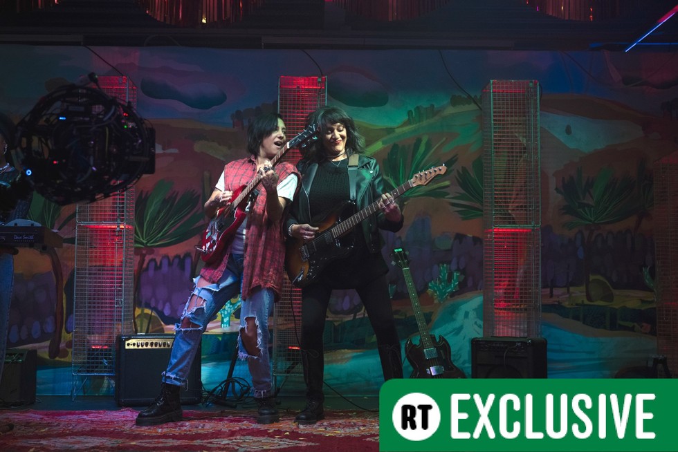 Sarah Kameela Impey as Saira and Meera Syal as Sister Squire in We Are Lady Parts season 2 Sarah Kameela Impey as Saira and Meera Syal as Sister Squire in We Are Lady Parts season 2. They are on stage playing guitar and there is a green banner in the bottom right corner reading RT Exclusive