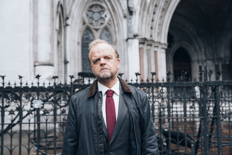 mr_bates_vs_the_post_office_ep4_01 Alan Bates (played by Toby Jones) stands outside a courthouse with a serious facial expression
