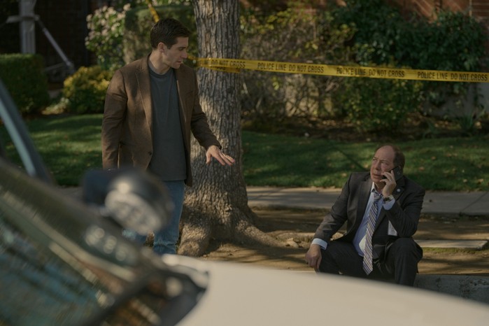Presumed_Innocent_Photo_010104 Jake Gyllenhaal and Bill Camp in Presumed Innocent. There is police tape behind them and Camp is sat on the floor