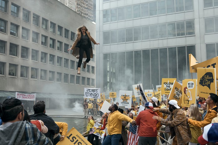 The Boys Season 4 Erin Moriarty as Starlight in The Boys, hovering over a crowd of protestors