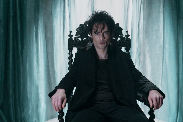 TheSandman_Unit_03646RC Tom Sturridge as Dream in The Sandman sitting in a chair.
